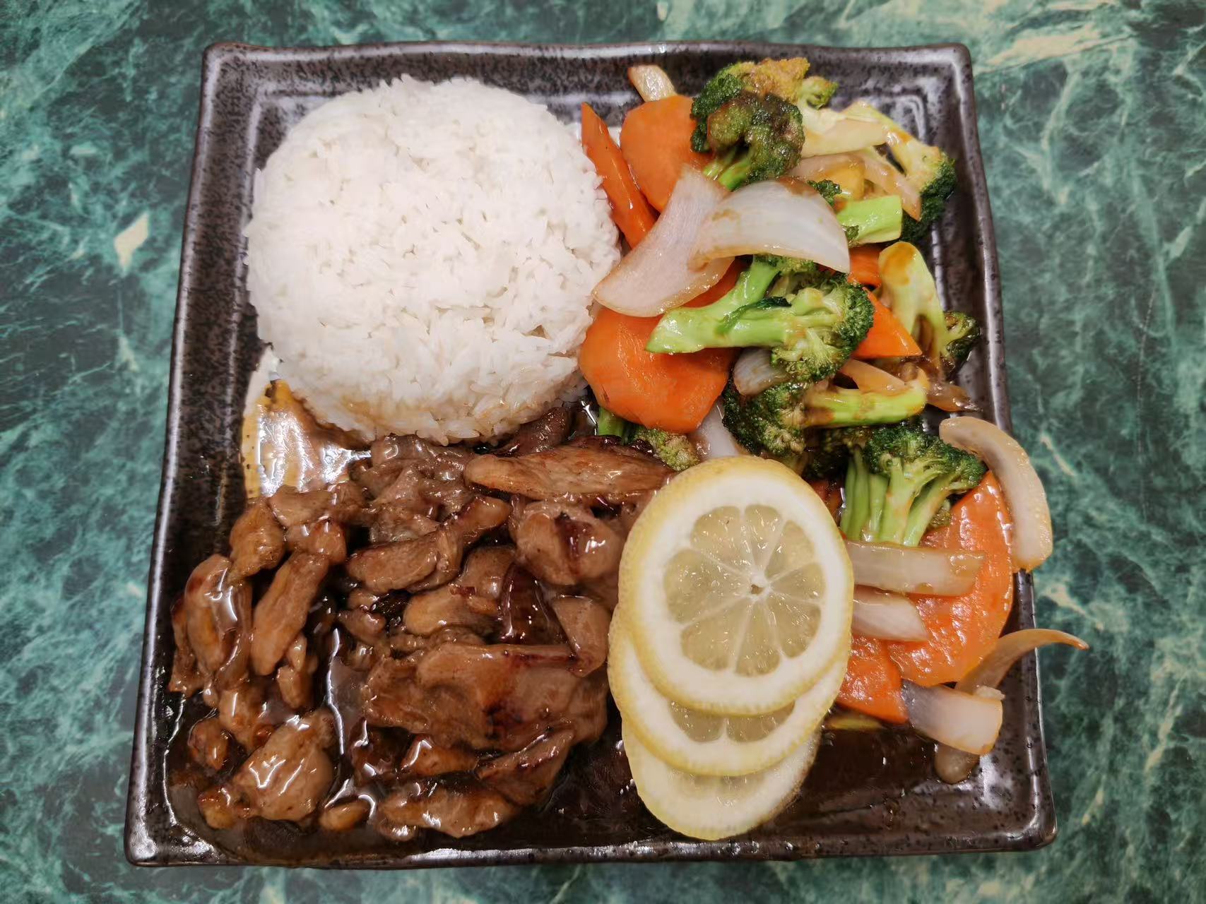 Teriyaki pork rice set with mixed veggies and lemon slices at Asia Hibachi & Rice Bowls，an Asian Fusion Restaurant in Buffalo