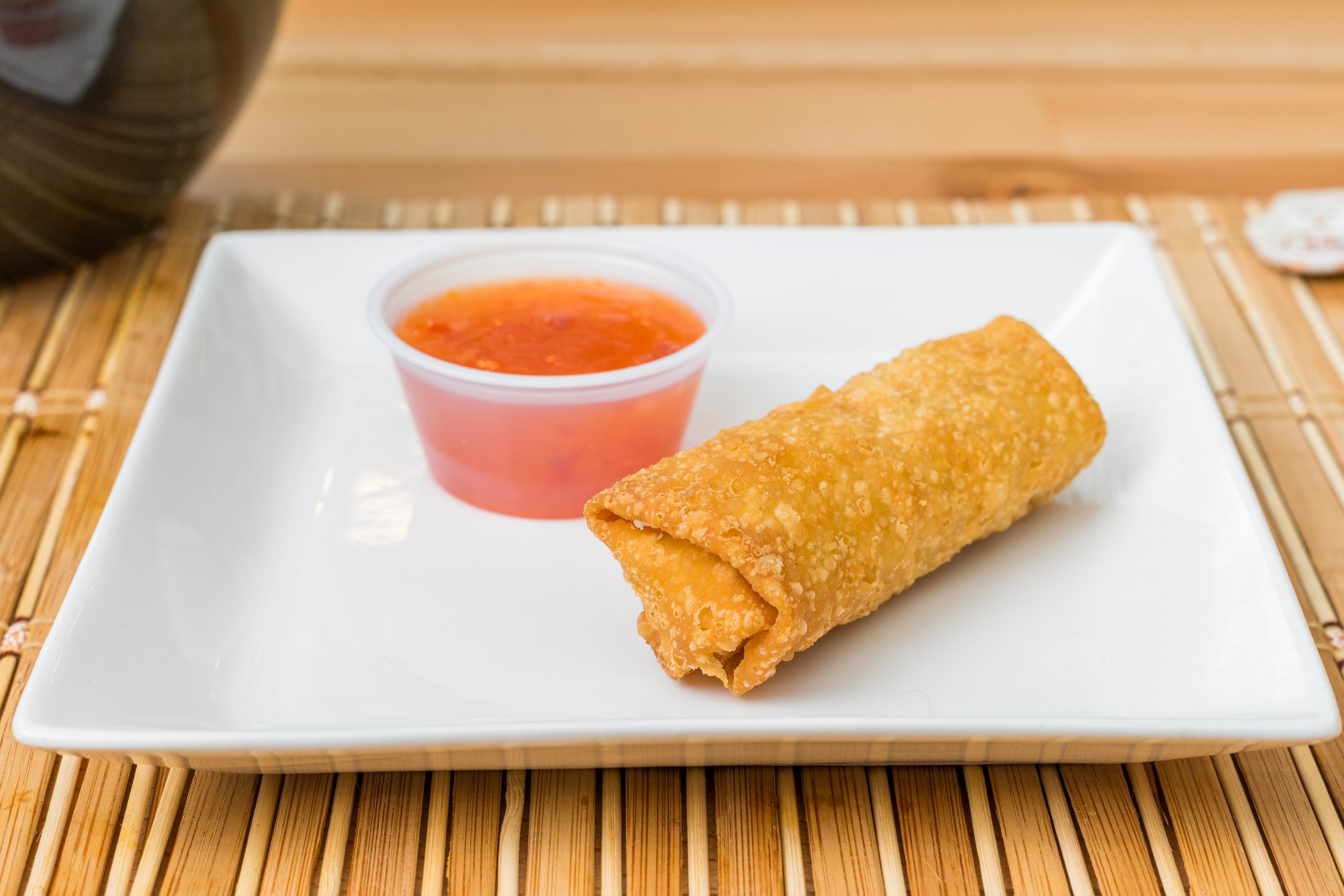 Crispy fried egg roll served with sweet chili sauce