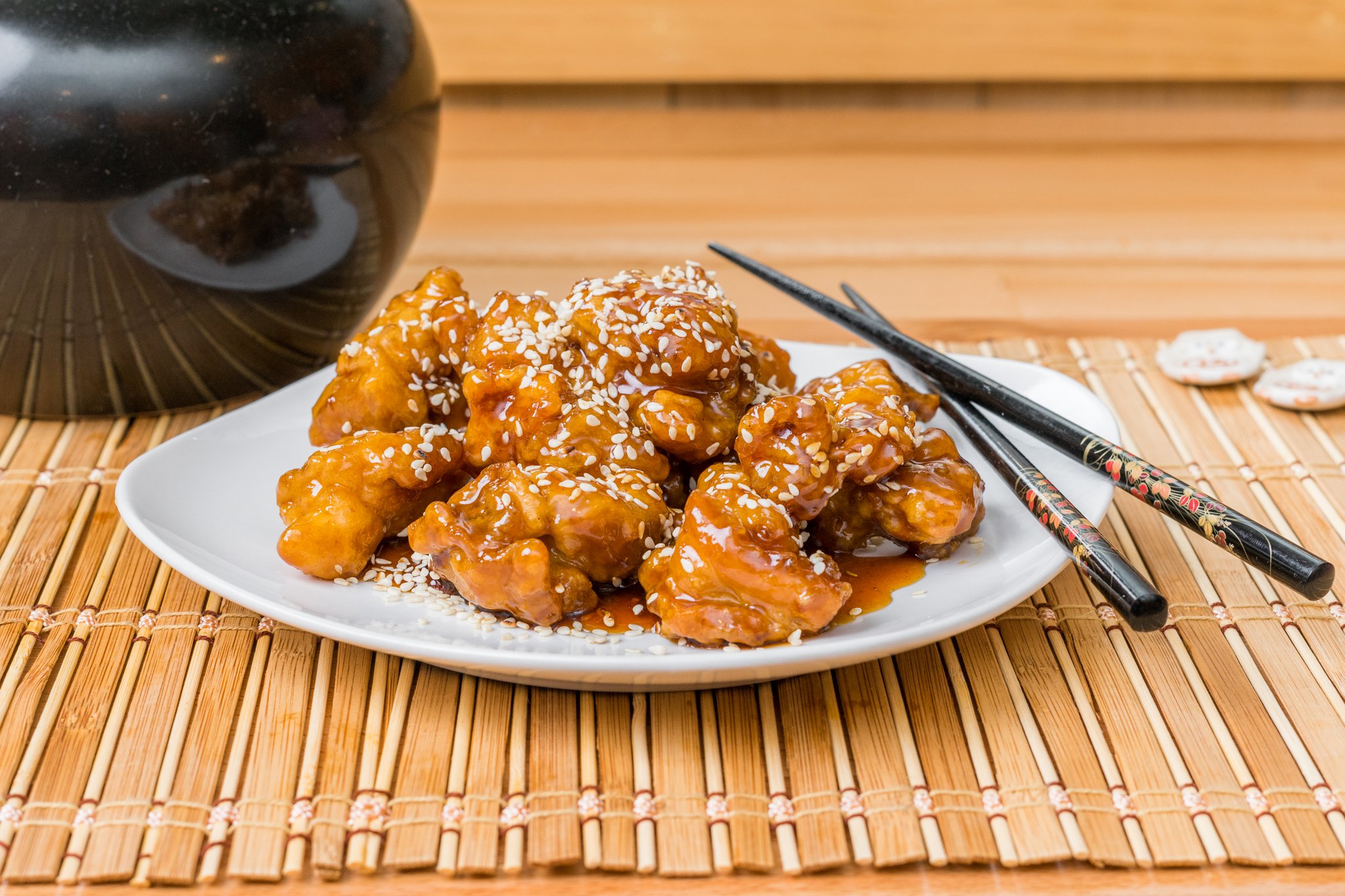 Crispy sesame chicken coated with sweet sticky sauce