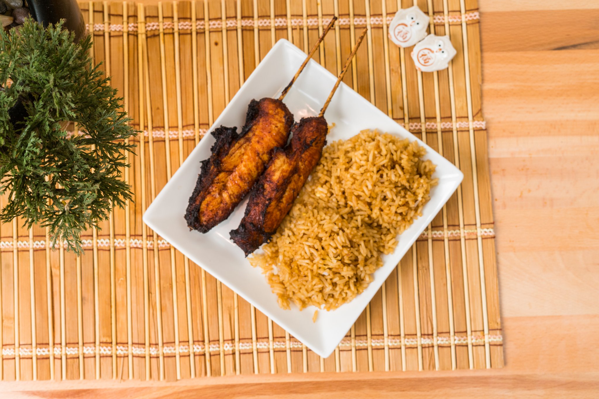 Grilled chicken satay skewers paired with seasoned fried rice.