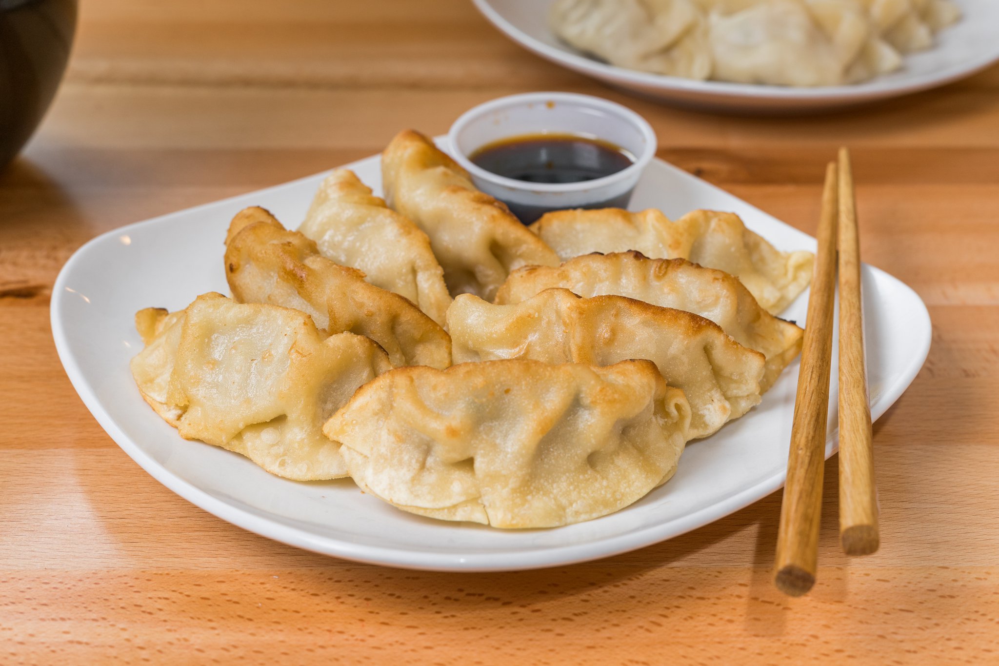 Pan-fried dumplings with soy dipping sauce