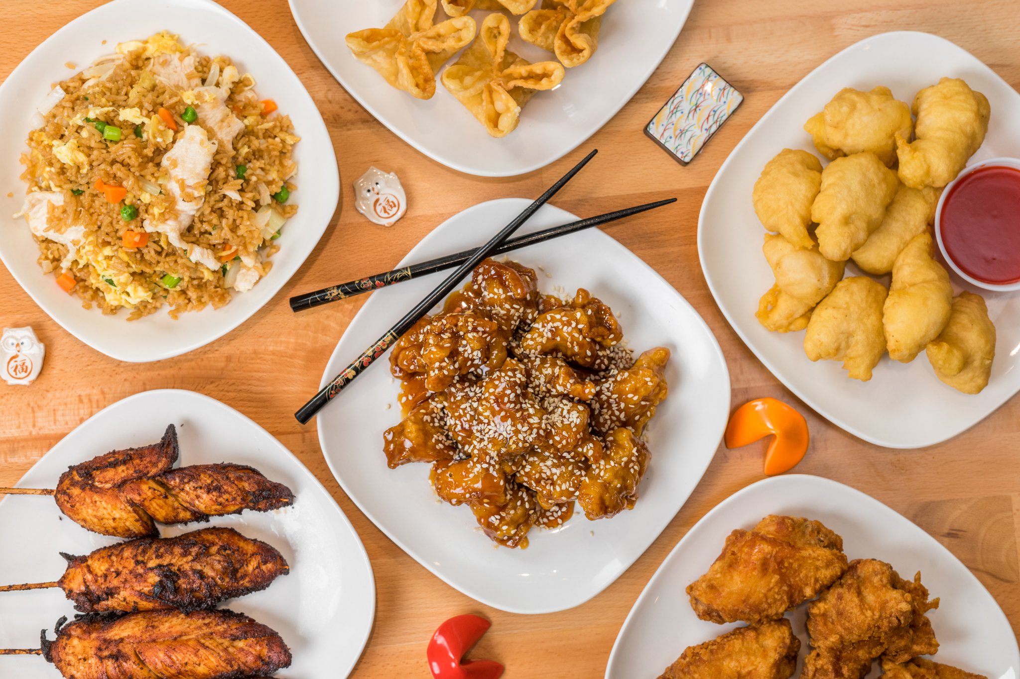 Top-down view of multiple popular Chinese takeout dishes.