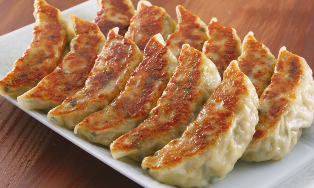 Pan‑fried dumplings with golden crust at Asian Plate, a Chinese Restaurant in Arcadia
