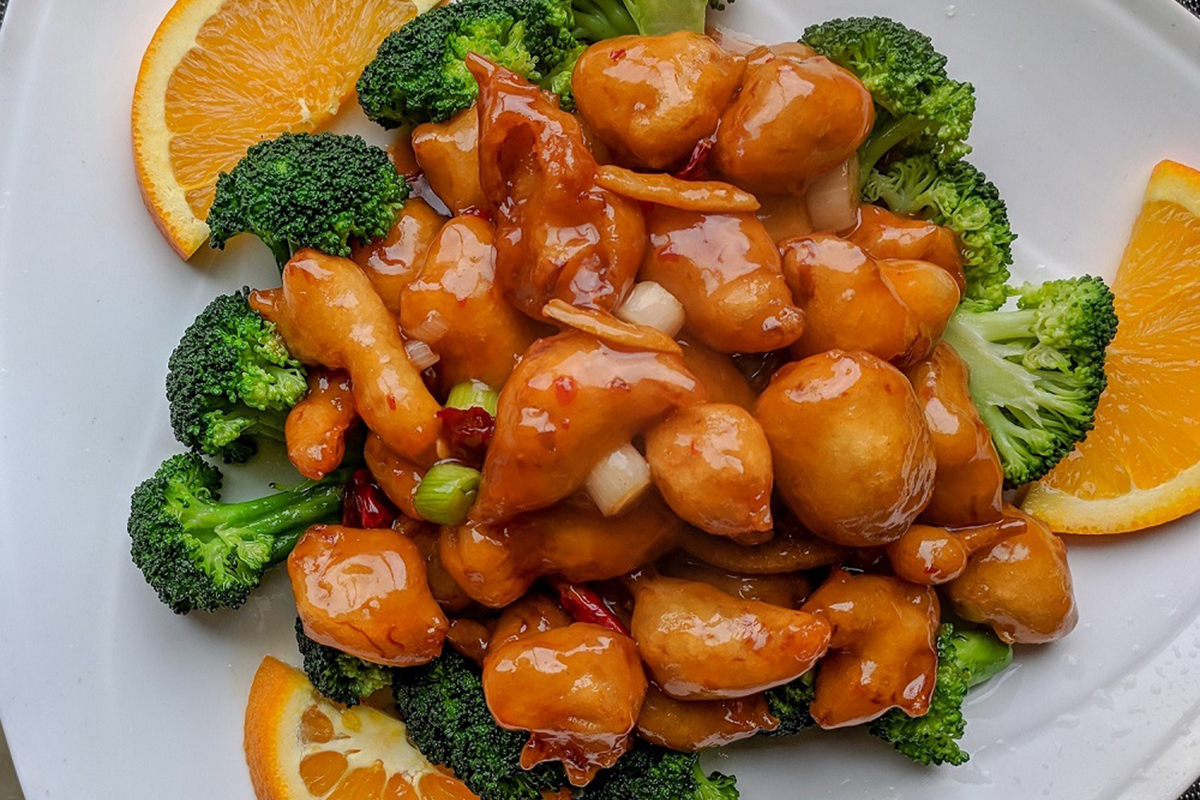 Orange chicken with broccoli and orange slices at Asuka, an Asian Fusion Restaurant in Bloomington