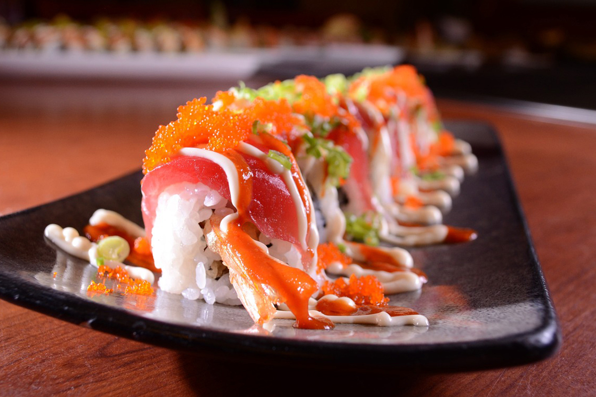 Spicy tuna roll with tobiko, sauces and green onion at Asuka, an Asian Fusion Restaurant in Bloomington