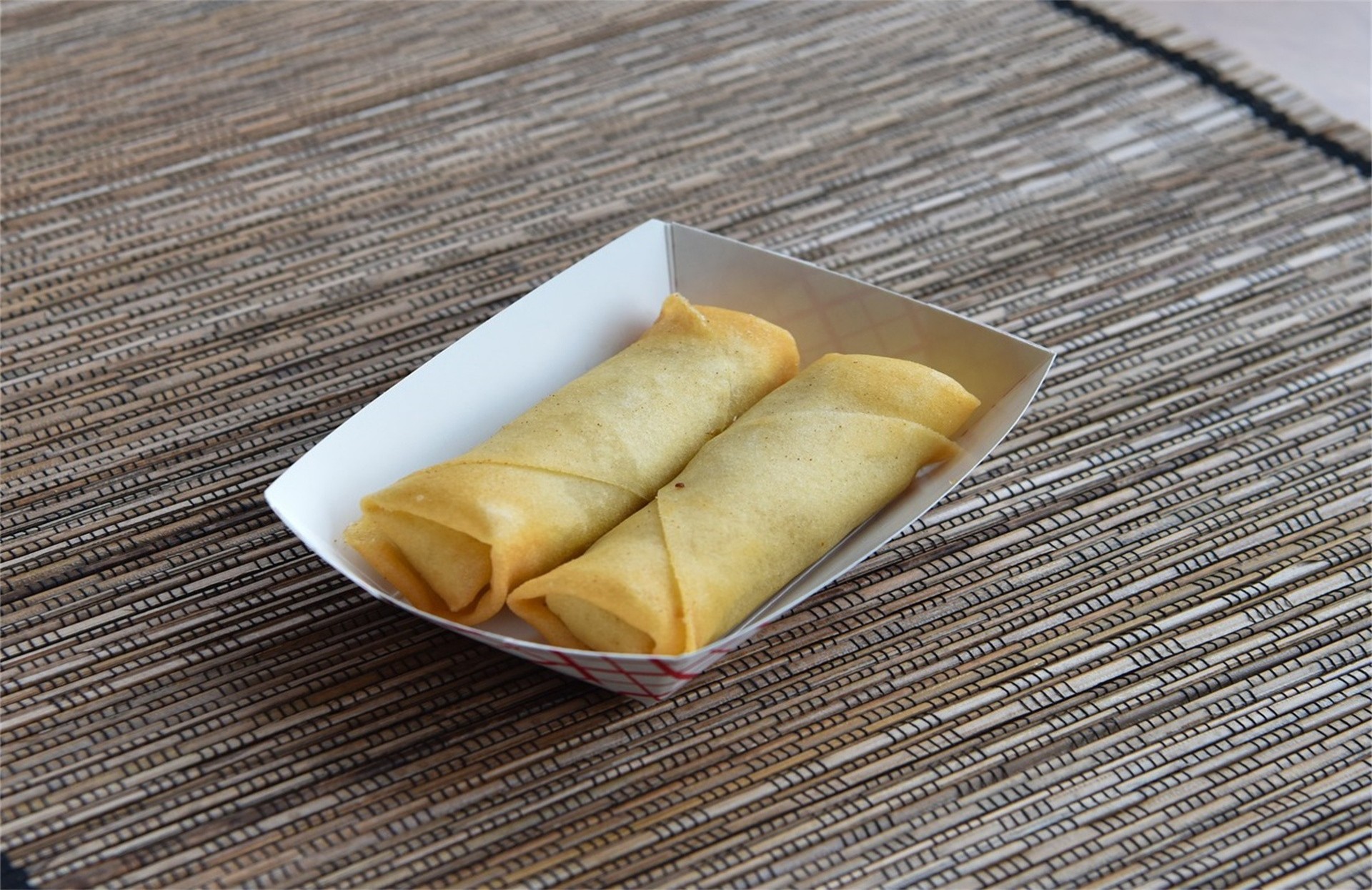 Two crispy fried spring rolls in paper tray at A Taste of Asia, a Chinese Restaurant in Marietta