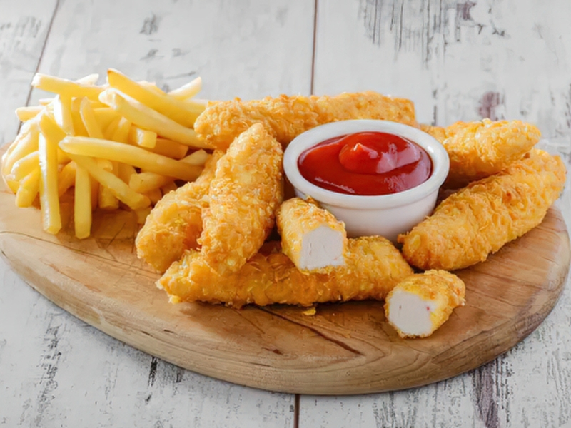 Crispy chicken tenders with fries and ketchup