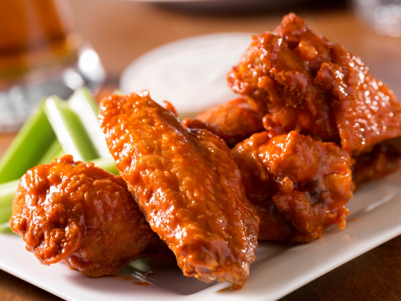Spicy buffalo chicken wings served with celery sticks