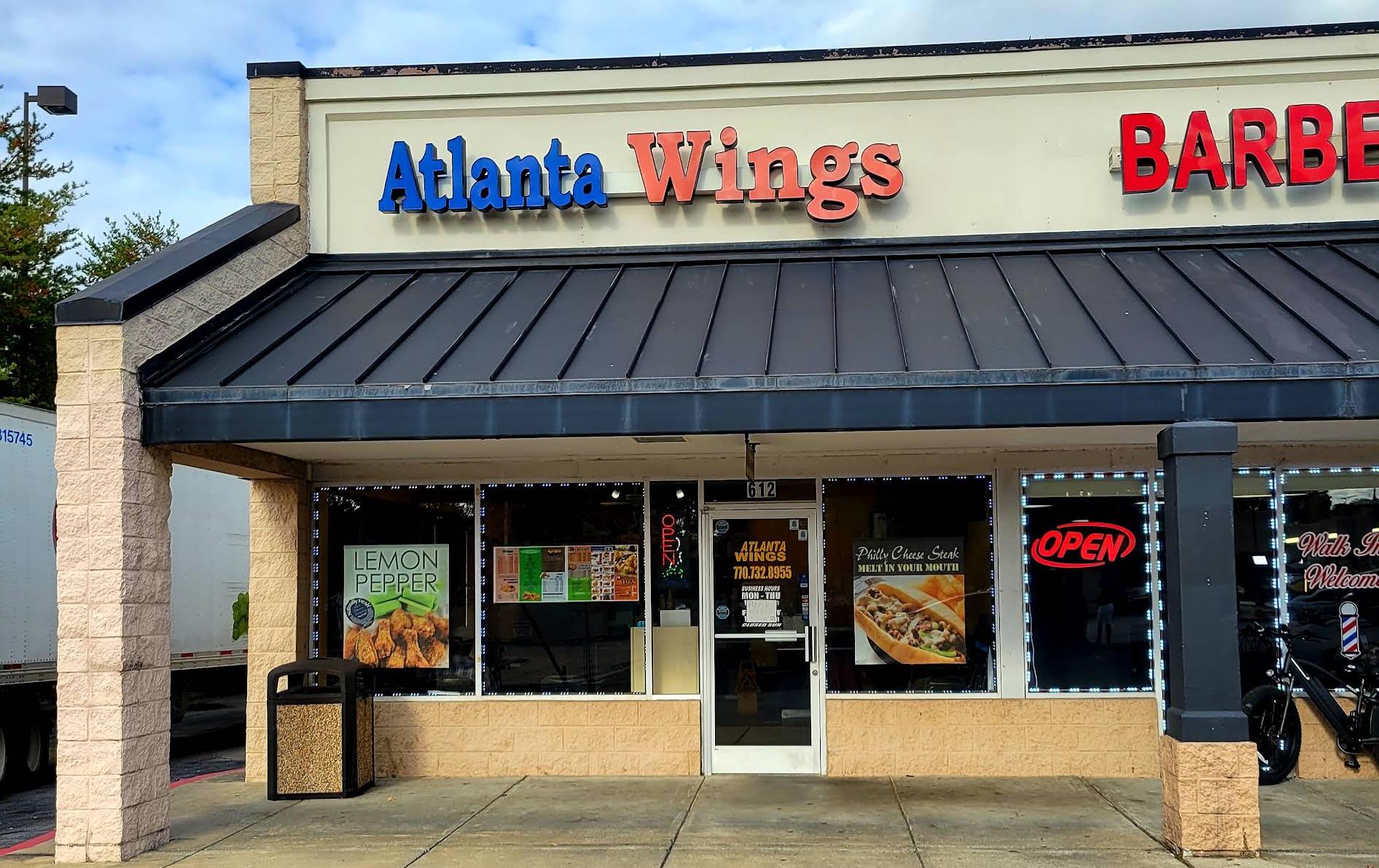 Storefront of Atlanta Wings restaurant with open sign