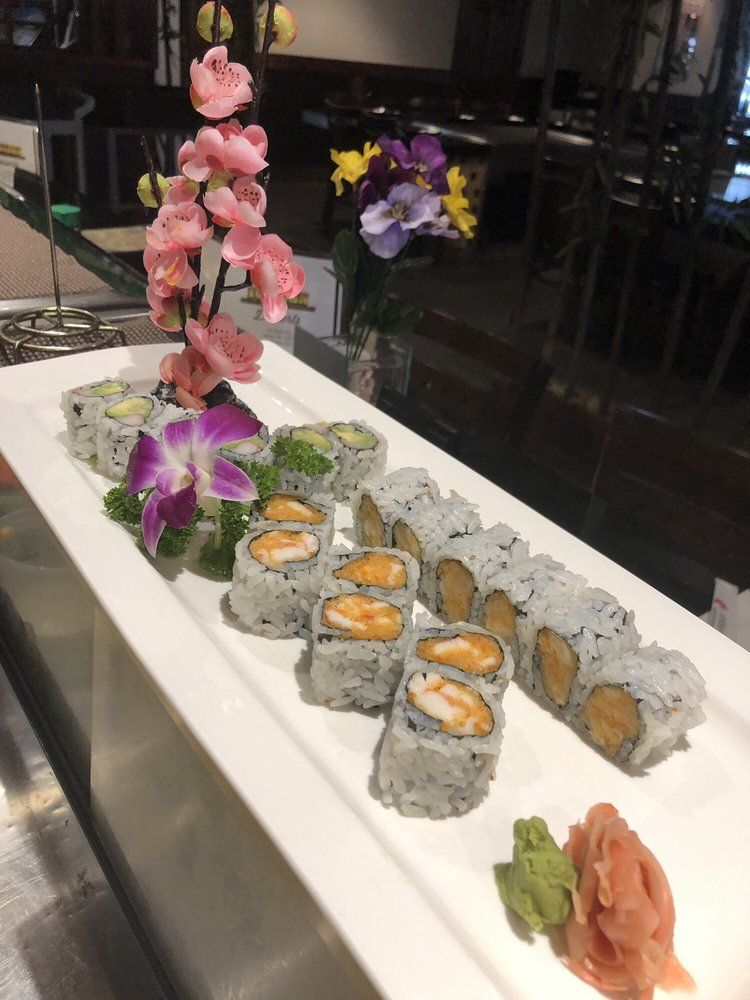 Assorted sushi rolls with edible flower garnish at Ichiban Sushi & Hibachi, a Japanese Restaurant in Auburn.