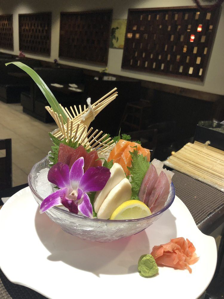 Colorful mixed sashimi platter with edible orchid at Ichiban Sushi & Hibachi, a Japanese Restaurant in Auburn.