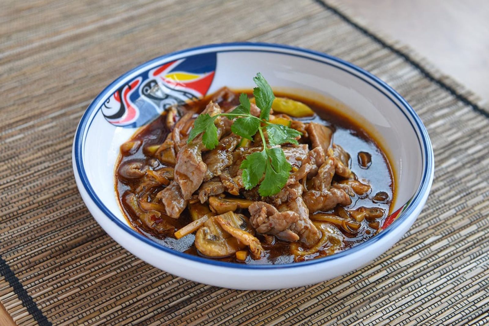 Spicy beef stir-fry with cilantro garnish at AYCE Bar & Wok, an Asian Fusion Restauran in Wind Gap