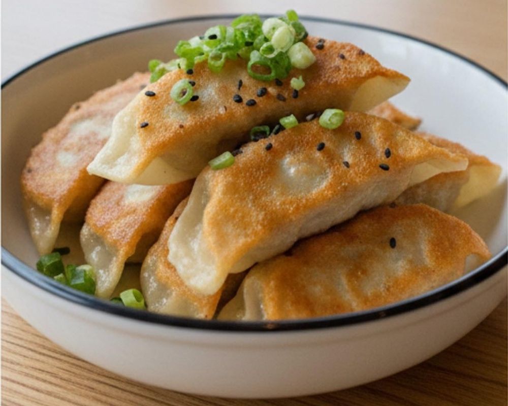Crispy pan fried dumplings with sesame and green onions at AZN Bowls. Bao. Juice Bar, a Health food Restaurant in Duluth