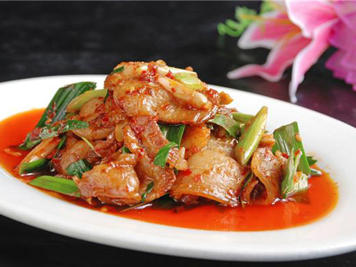 Twice cooked pork stir-fried with green leeks and spicy red sauce on an oval plate at Bamboo Express, a Chinese Restaurant in Bellingham