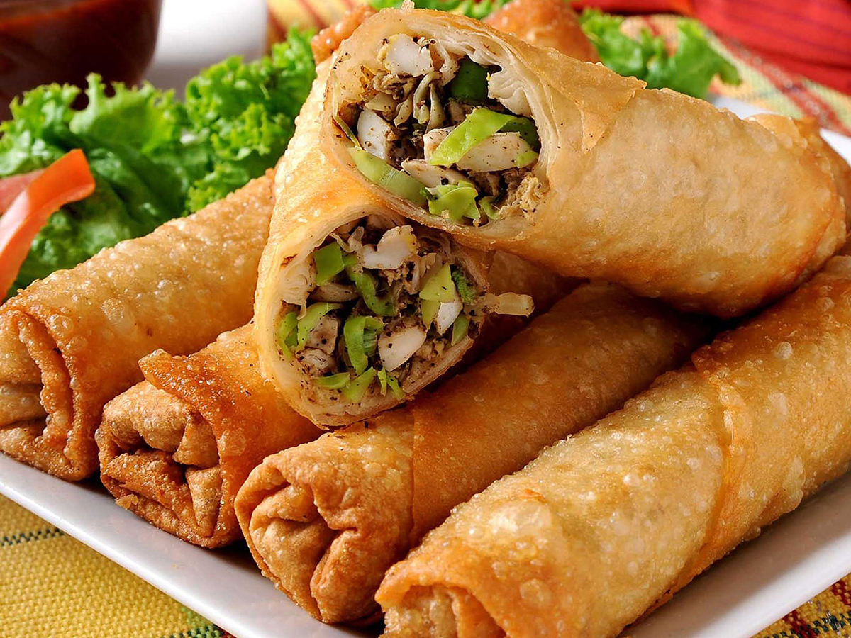 Fried vegetable spring rolls, one cut open to show filling, arranged on a white plate at Bamboo Express, a Chinese Restaurant in Bellingham