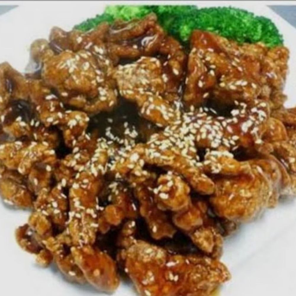 Sesame beef coated in glossy dark sauce sprinkled with white sesame seeds at Bamboo Moon Chinese&Japanese Bubble Tea, an Asian Fusion Restaurant in Randolph