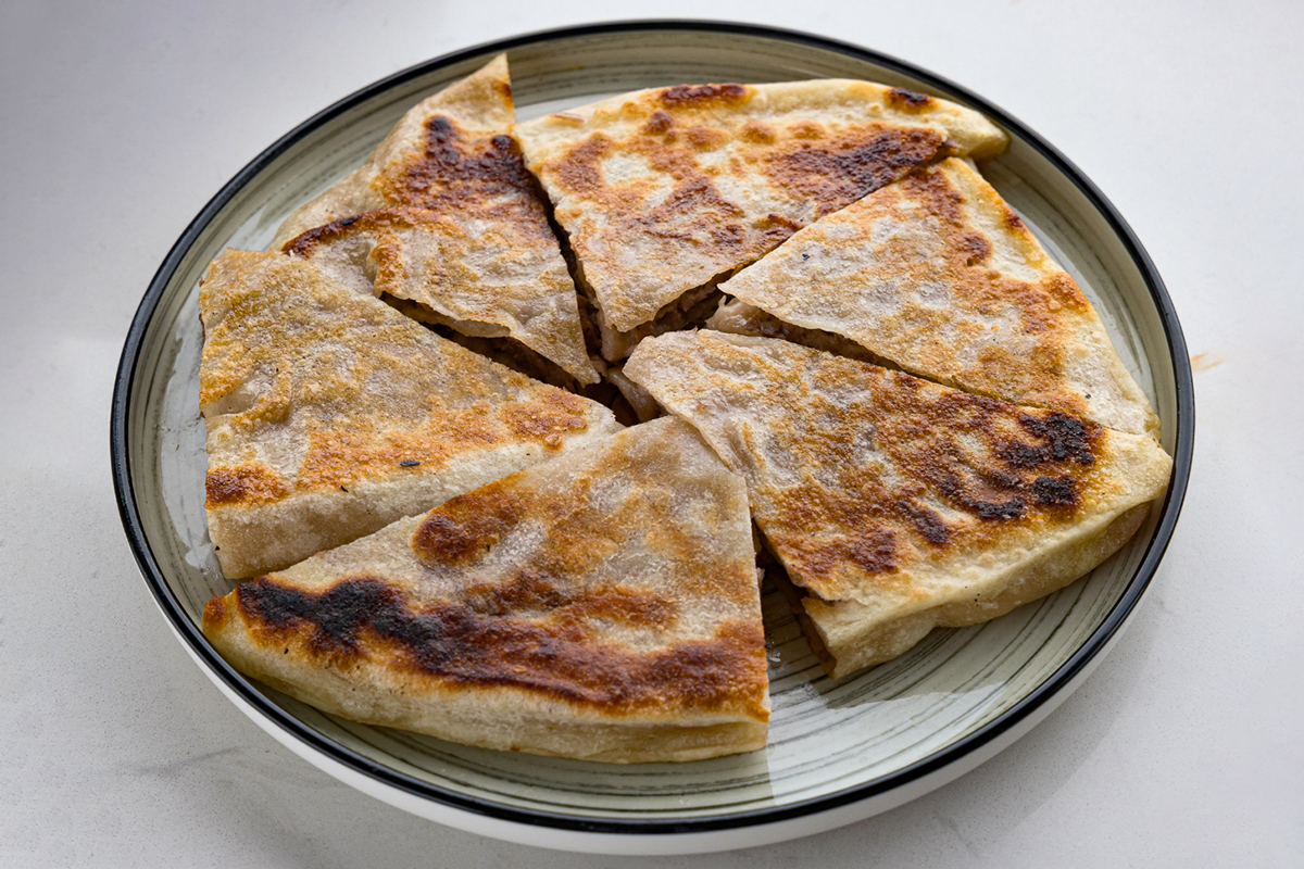 Crispy beef pancake cut into wedges at Baobao Asian Eatery, an Asian Restaurant in Ann Arbor