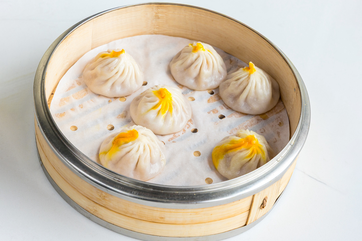Steamed crab meat soup dumplings in bamboo steamer at Baobao Asian Eatery, an Asian Restaurant in Ann Arbor