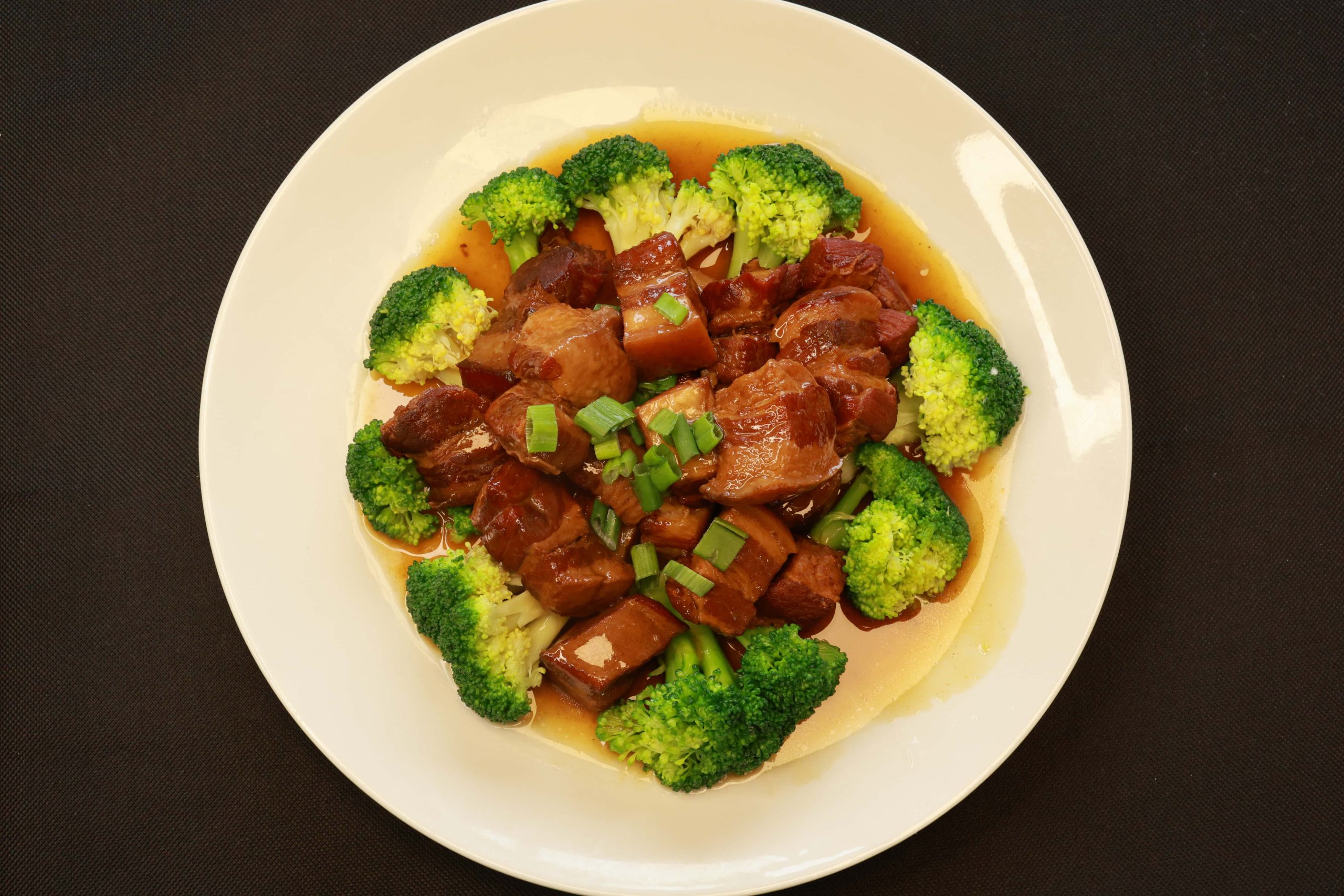 Tender braised pork cubes with glossy sauce and broccoli at Bao House, a Chinese Restaurant in Stillwater
