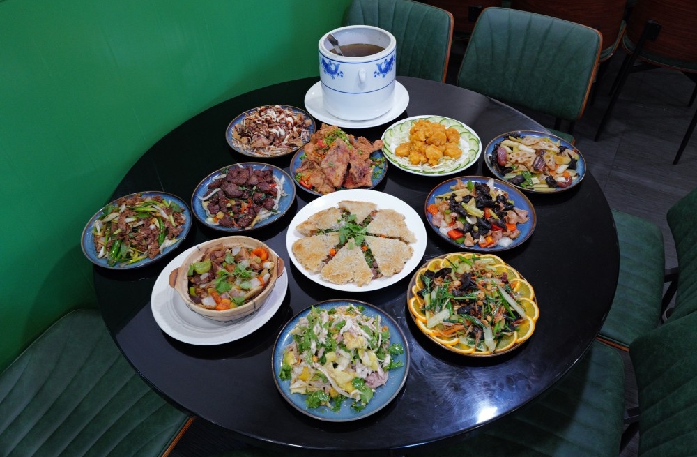 Variety of Chinese dishes including soups, stir-fries, and salads, served on a table at Bao Kee Restaurant, a Chinese Restaurant in Hacienda Heights