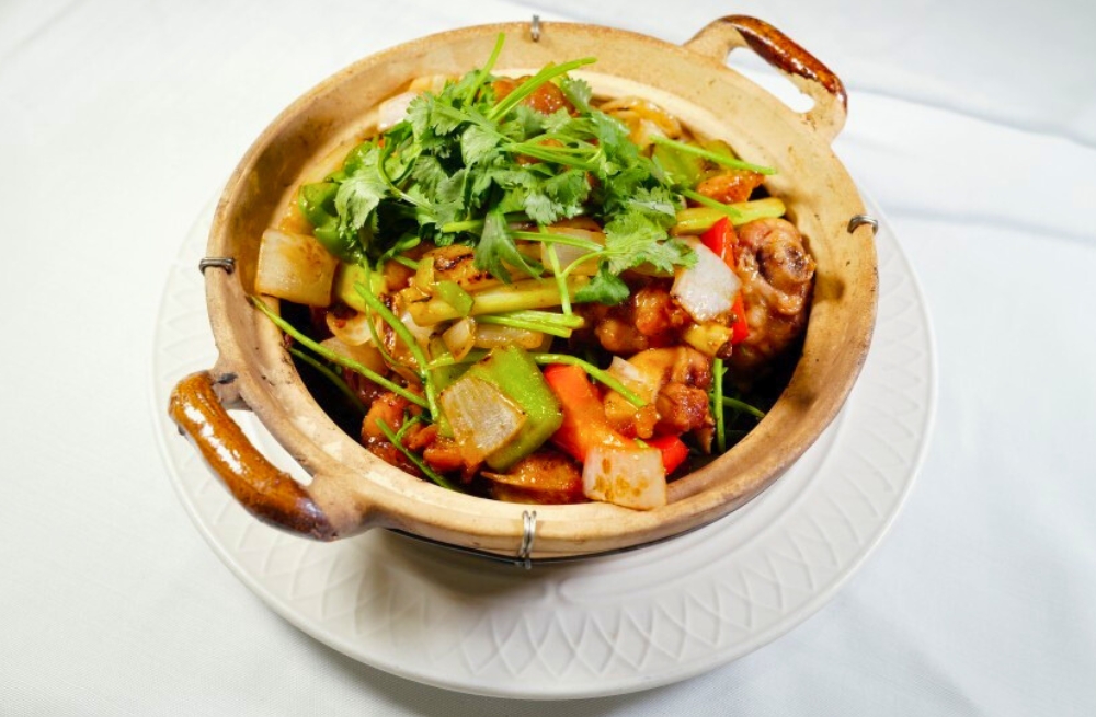 Flavorful chicken with vegetables in clay pot, garnished with cilantro at Bao Kee Restaurant, a Chinese Restaurant in Hacienda Heights