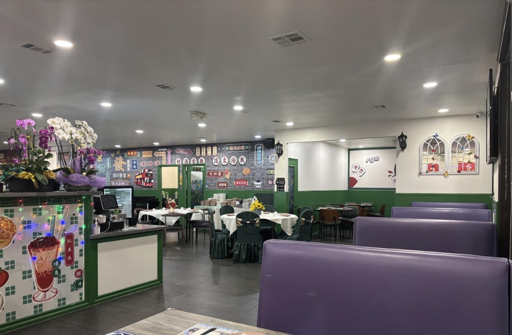 Inviting dining area with vibrant murals, a counter with flowers, and comfortable seating at Bao Kee Restaurant, a Chinese Restaurant in Hacienda Heights