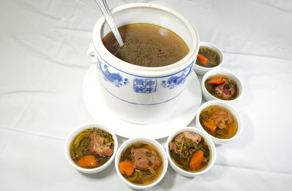 Nourishing herbal meat soup served in a large pot and small bowls, hearty and aromatic at Bao Kee Restaurant, a Chinese Restaurant in Hacienda Heights