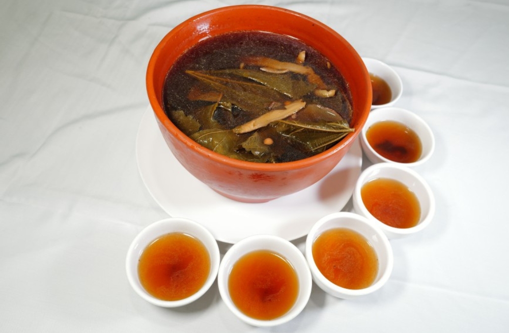 Herbal tea soup with leaves and roots, served in a clay pot and small cups at Bao Kee Restaurant, a Chinese Restaurant in Hacienda Heights