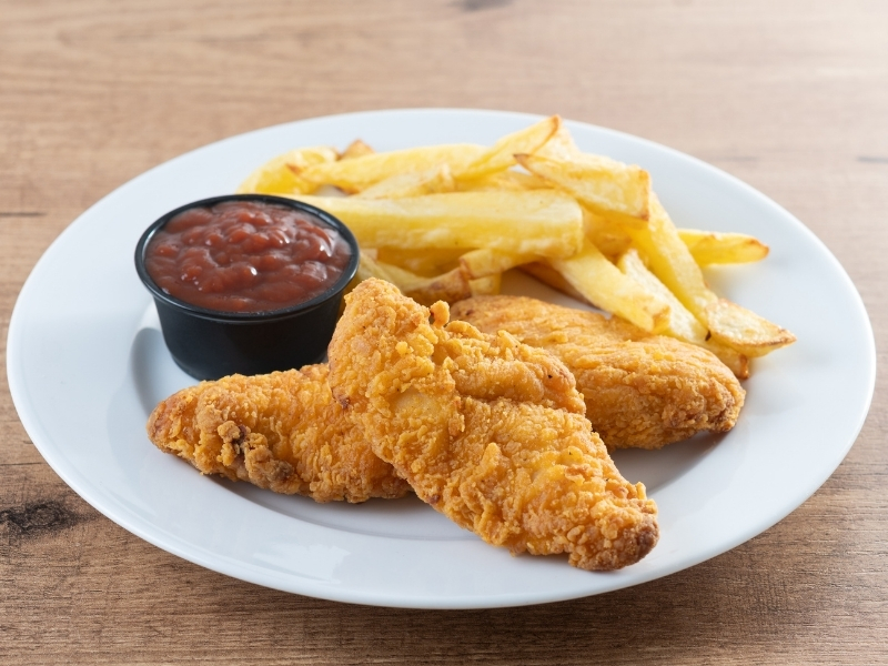 Crispy fried chicken tenders with thick-cut fries and ketchup at Bayou Crab, a Seafood Restaurant in Lake Jackson