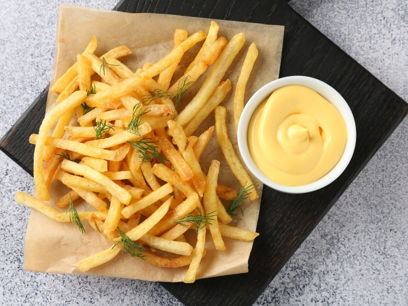 Golden french fries with fresh herbs and creamy cheese dip at Bayou Crab, a Seafood Restaurant in Lake Jackson