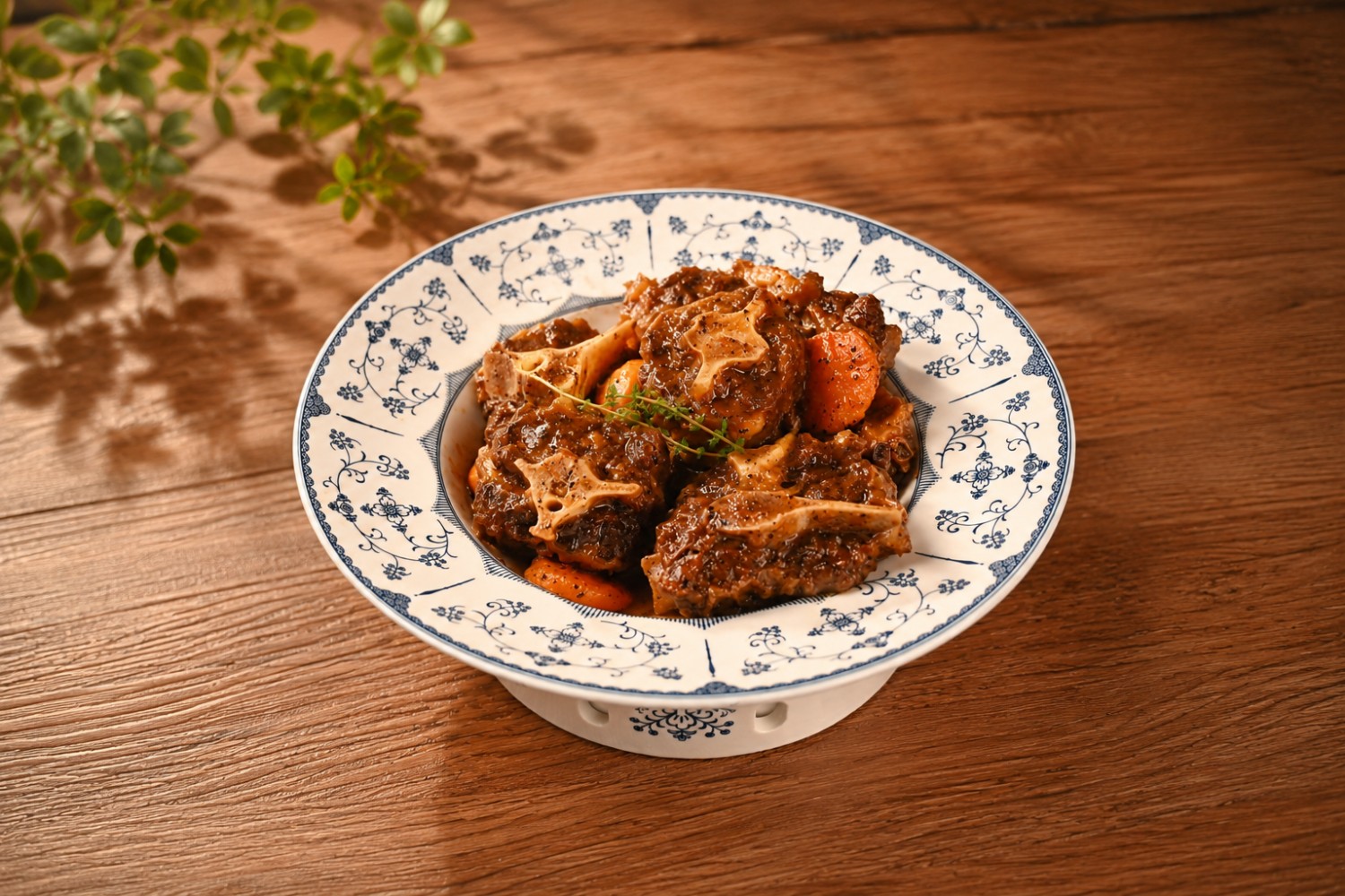 Glazed oxtail dish with carrots on a patterned plate at Beijing Tasty House, a Chinese Restaurant in San Gabriel