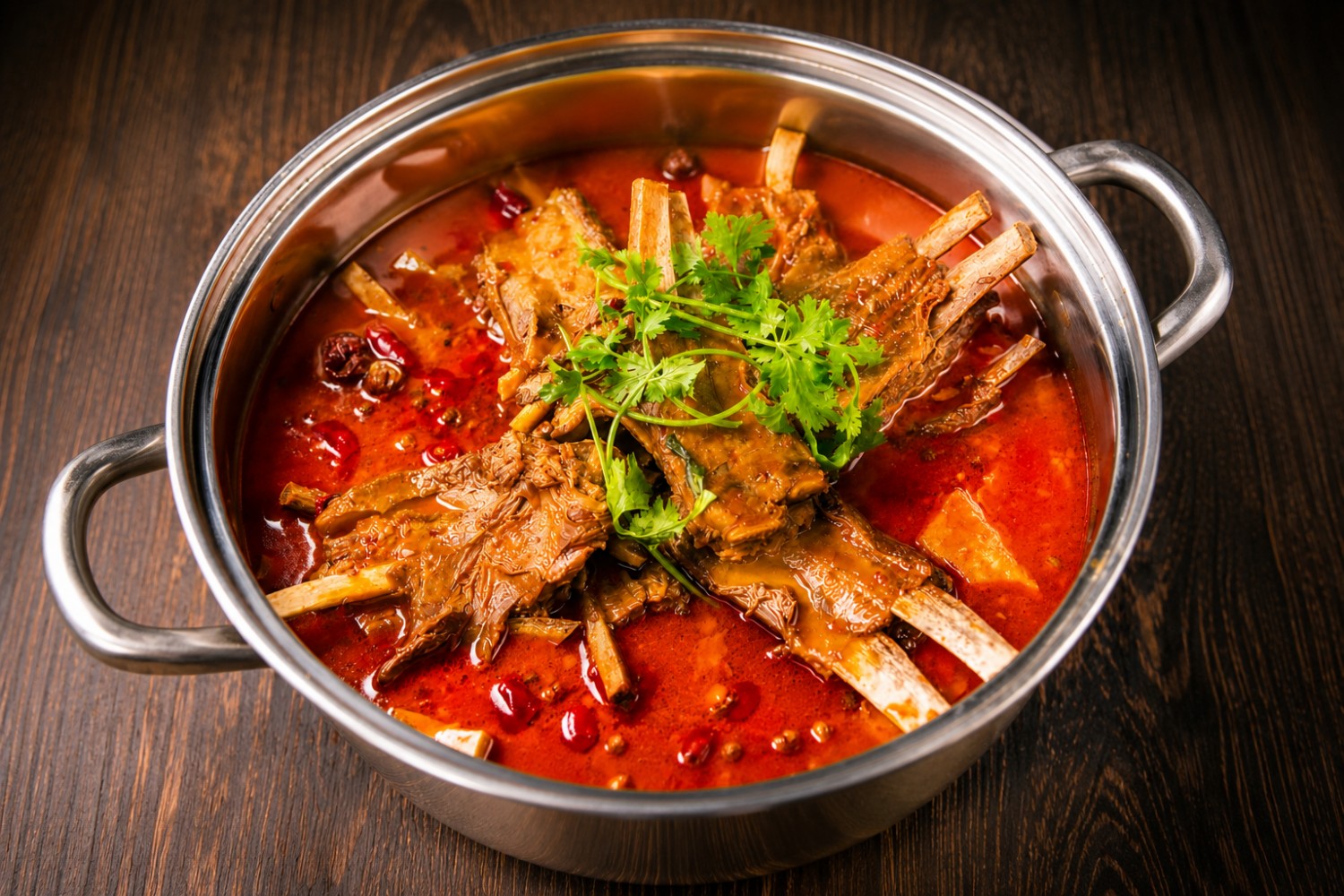 Spicy lamb hot pot with red broth and herbs at Beijing Tasty House, a Chinese Restaurant in San Gabriel