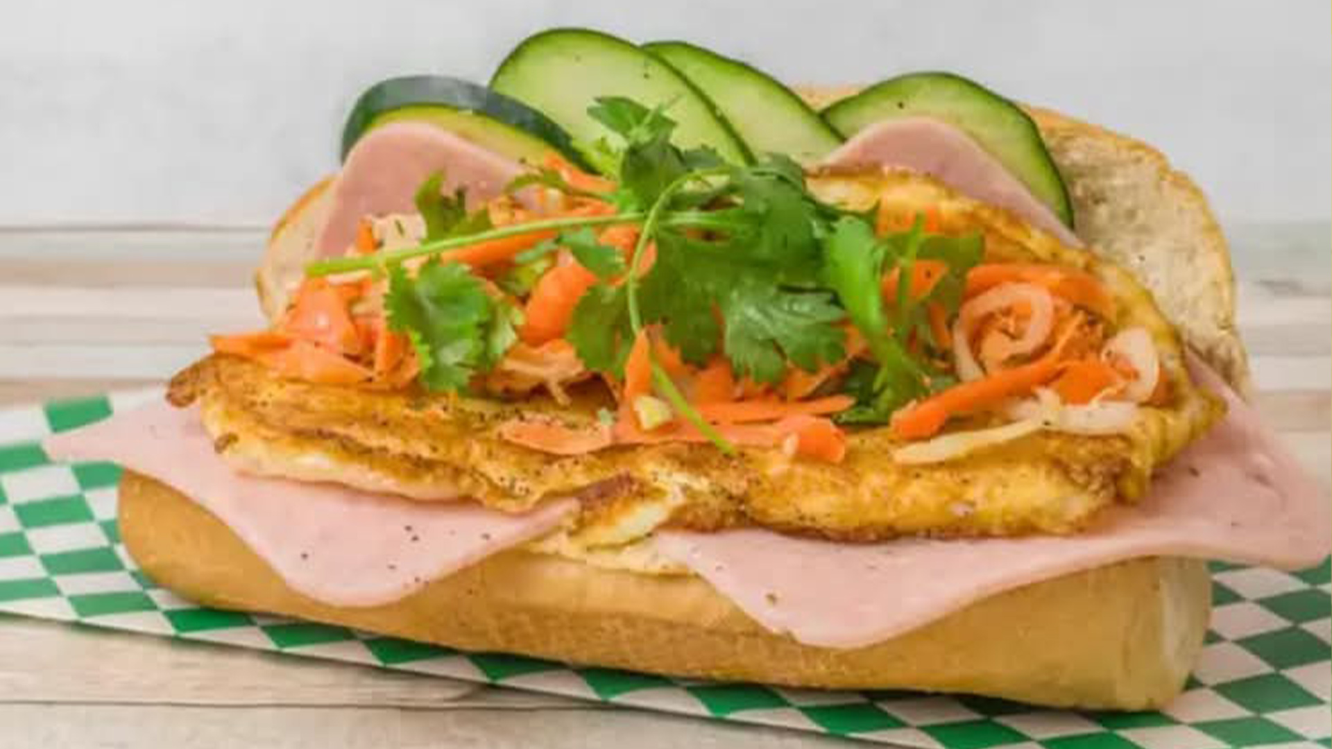 Banh mi with ham, fried egg, veggies at Big Boss Banh Mi, a Vietnamese Restaurant in Houston