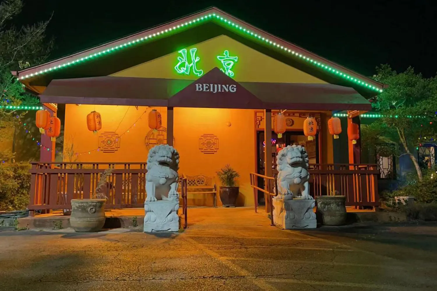 Night exterior with stone lions and neon sign at Beijing Restaurant，a Chinese Restaurant in San Antonio
