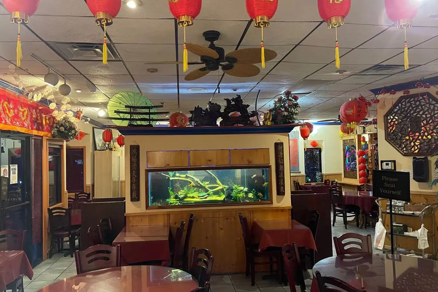 Restaurant dining area with couplets beside fish tank at Beijing Restaurant，a Chinese Restaurant in San Antonio