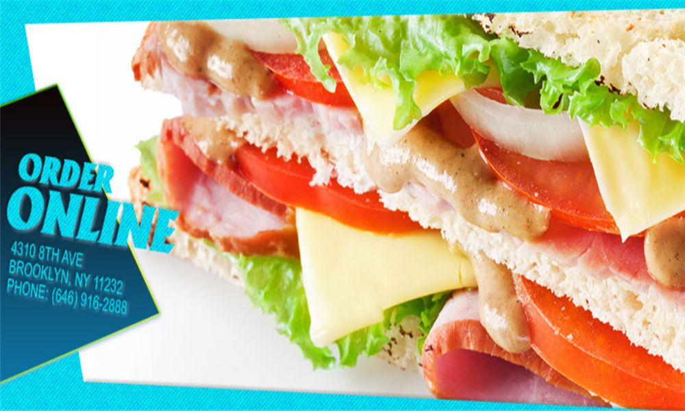 A close-up of a gourmet burger with fresh lettuce, tomato, cheese sauce, and grilled chicken on a toasted bun at MBL&Q Burger, a Lunch Restaurant in Brooklyn
