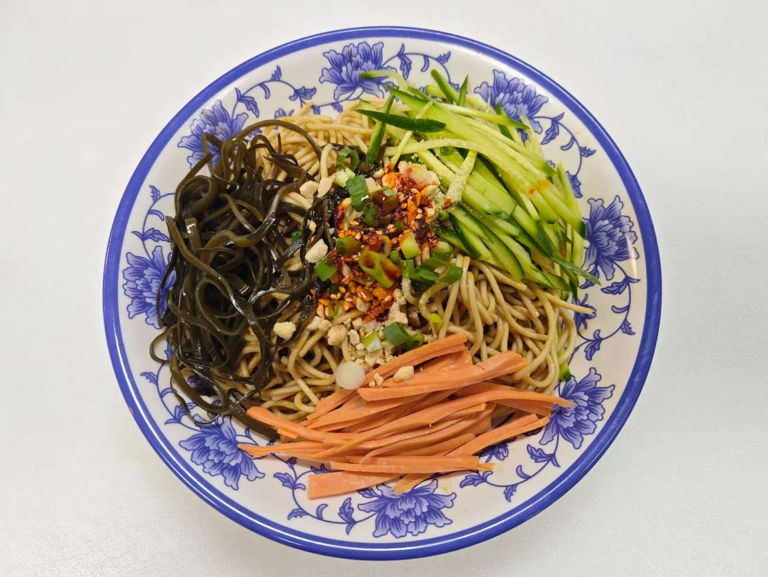 Blue & White-Fried-Rice & Noodles-Asian-Restaurant-Cold-Noodles-Las-Vegas A plate of cold noodles, with a variety of toppings and a light sauce at Blue & White Fried Rice & Noodles,a Chinese Restaurant in Las Vegas
