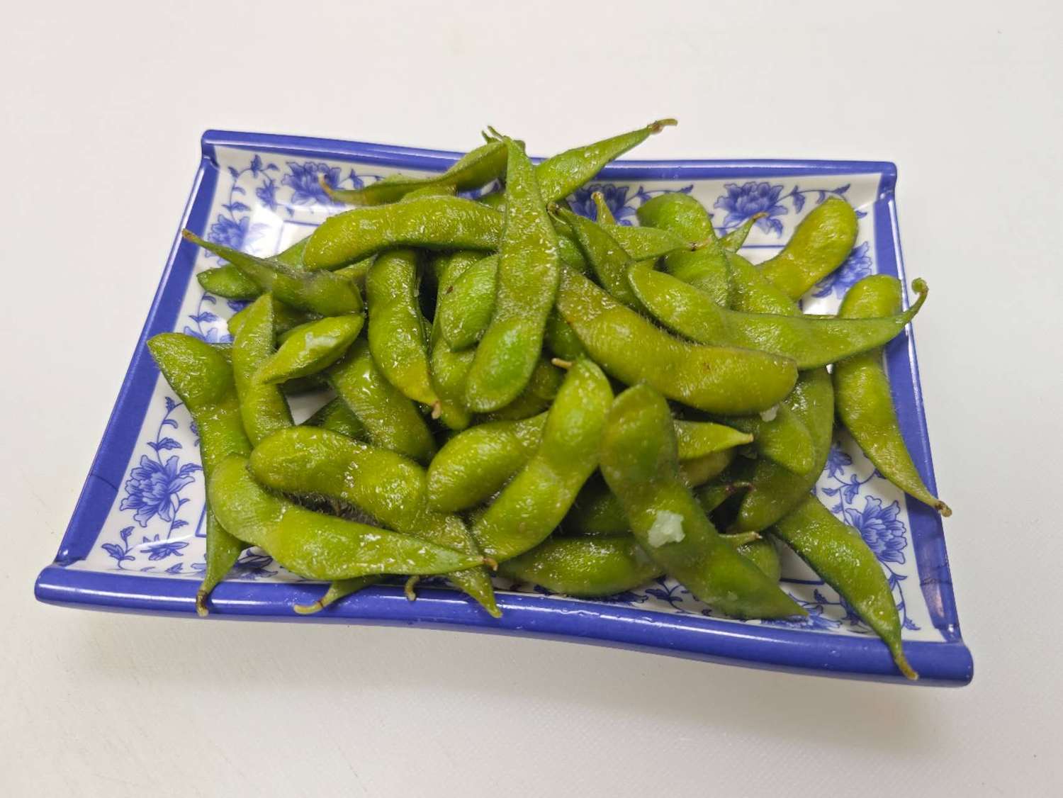 Blue & White-Fried-Rice & Noodles-Asian-Restaurant-Salted-Edamame-Las-Vegas A plate of salted edamame, fresh and green, a perfect appetizer at Blue & White Fried Rice & Noodles,a Chinese Restaurant in Las Vegas