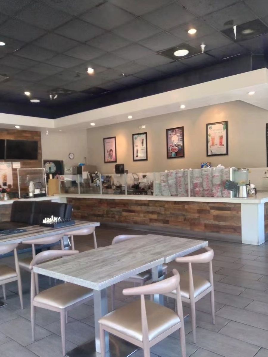 Cozy dining area with tables and chessboard at Blue Elephant Thai Ice Cream and Drink, a Ice cream shop in Murrieta