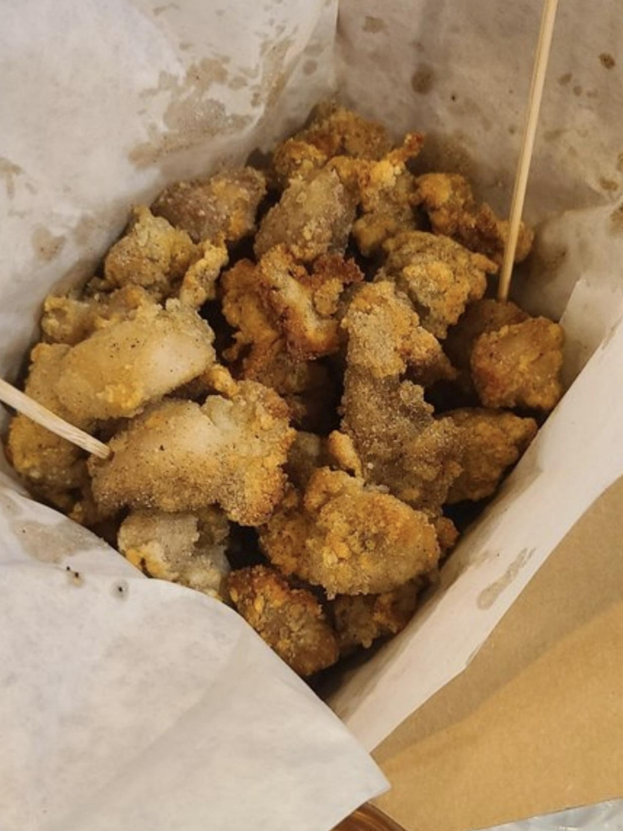 Crispy fried chicken pieces in a paper bag at Blue Elephant Thai Ice Cream and Drink, a Ice cream shop in Murrieta