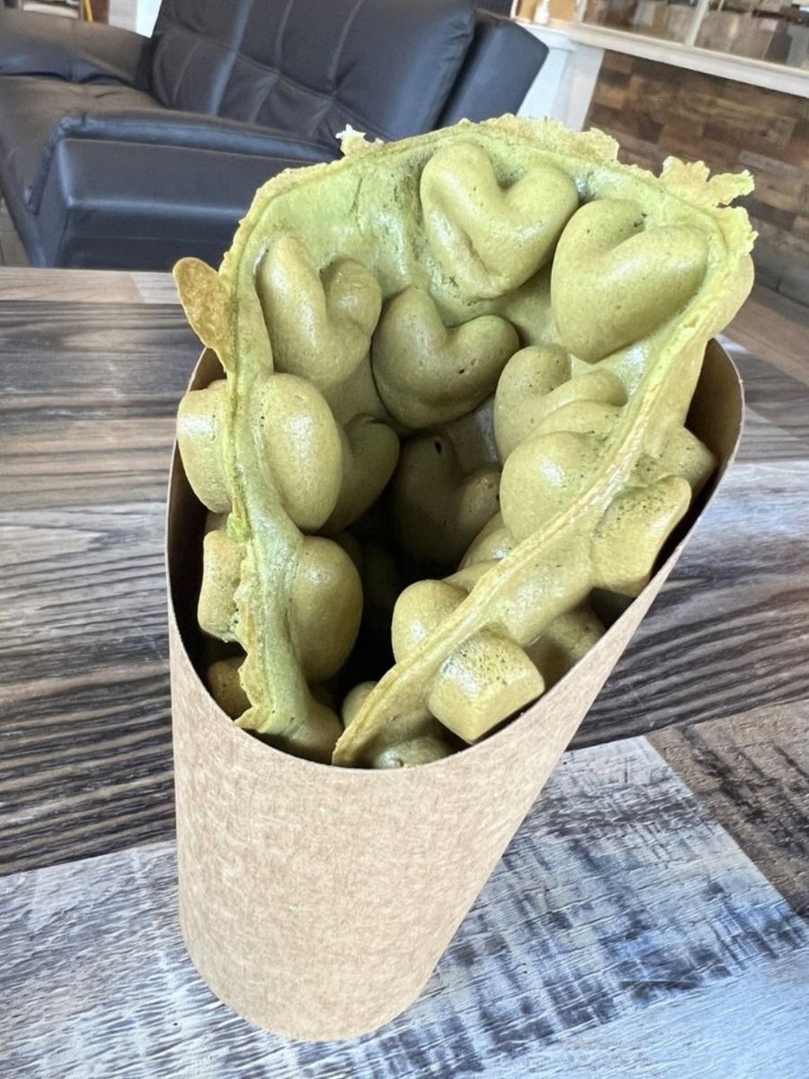 Crispy matcha egg waffle in paper holder at Blue Elephant Thai Ice Cream and Drink, a Ice cream shop in Murrieta