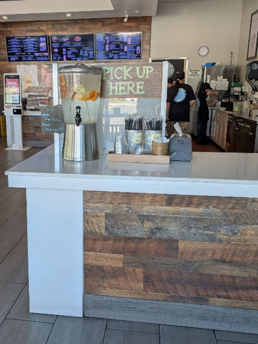 Store pick-up counter with drink dispenser and menu boards at Blue Elephant Thai Ice Cream and Drink, a Ice cream shop in Murrieta