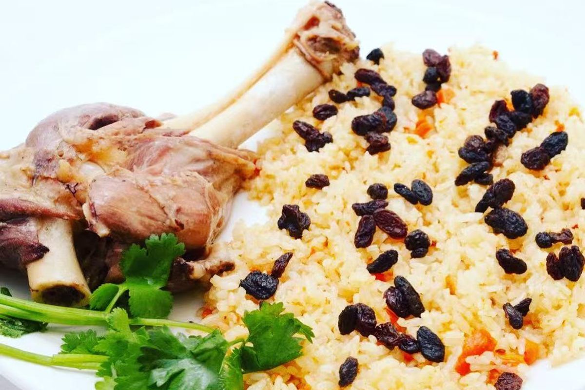 Lamb leg plov with raisins and carrots at Bogda Uyghur Restaurant, a Chinese Halal Restaurant in Plano