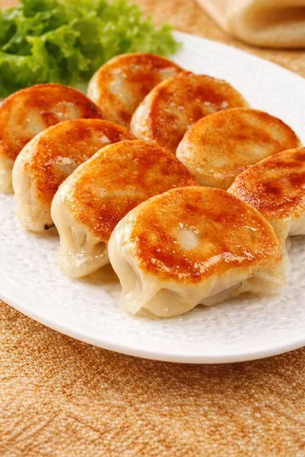 Crispy golden pan-fried dumplings served on white plate at ENÓ Dumplings of Love, Handmade Dumplings Restaurant in North Las Vegas