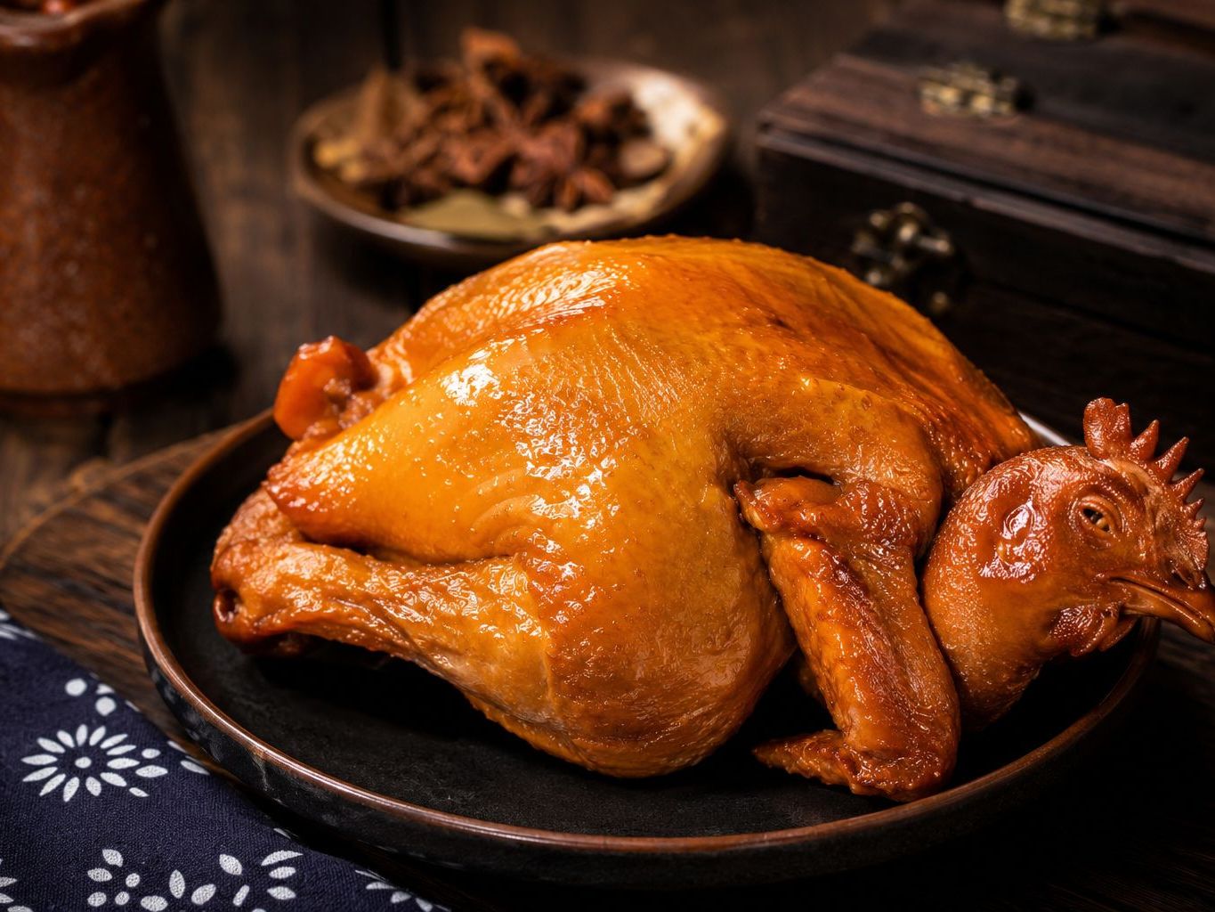 Whole tender braised chicken with shiny amber skin at Braised Canaan, a Chinese Restaurant in Flushing