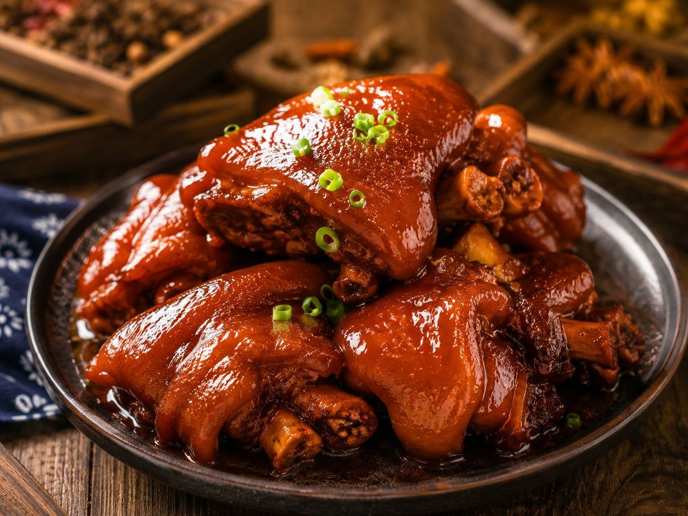 Braised pork knuckles coated in thick red sauce with chopped green onion at Braised Canaan, a Chinese Restaurant in Flushing
