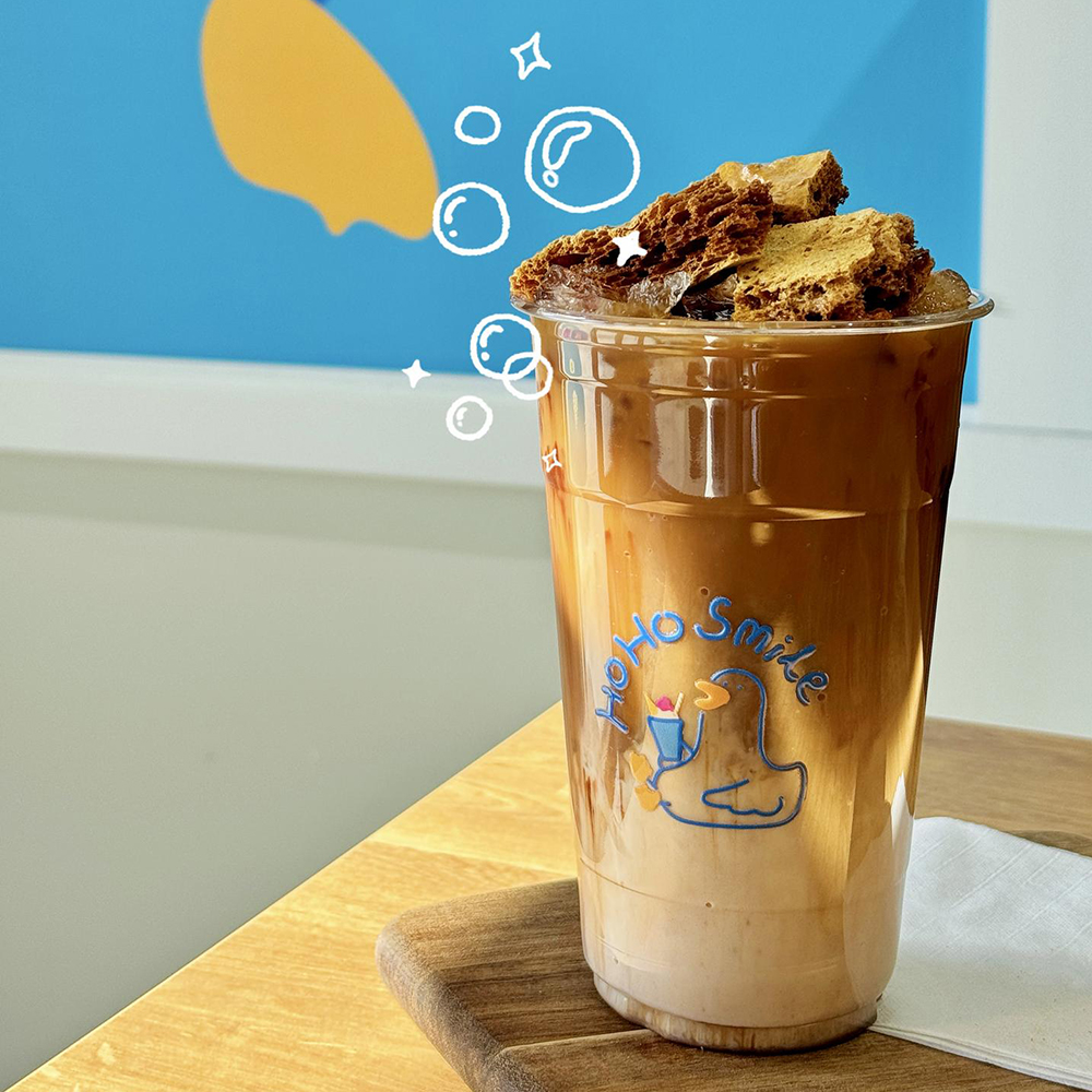 Iced coffee with honeycomb crunch topping in a plastic cup at Bull King Steak House，a Asian Fusion Steakhouse in Glendale