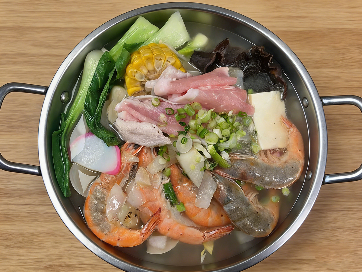 Shrimp and pork hot pot with vegetables in a metal pot at Bull King Steak House，a Asian Fusion Steakhouse in Glendale