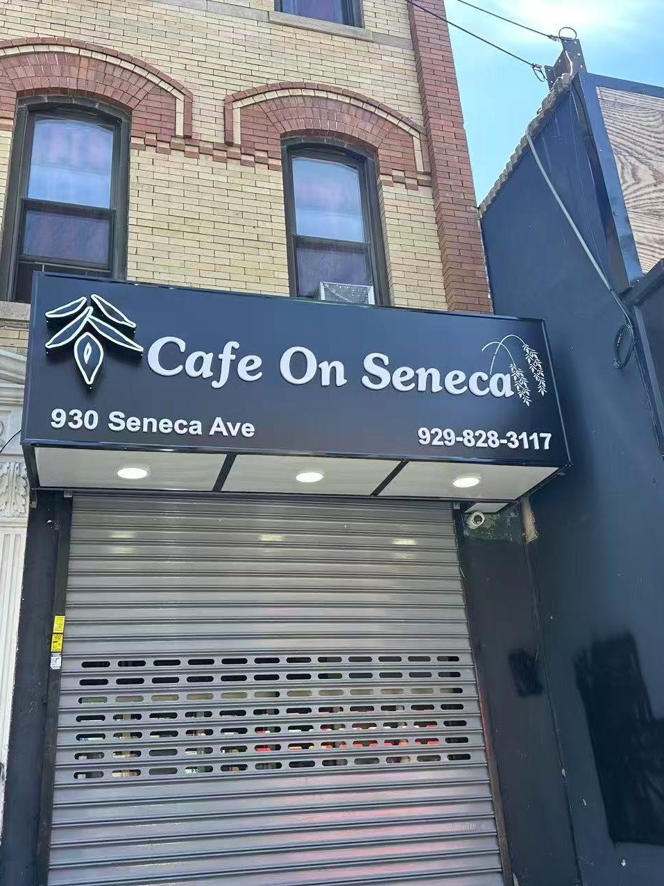 Brick building storefront with black Cafe On Seneca sign, address and phone number at Cafe On Seneca, an Asian Fusion Restaurant in Ridgewood
