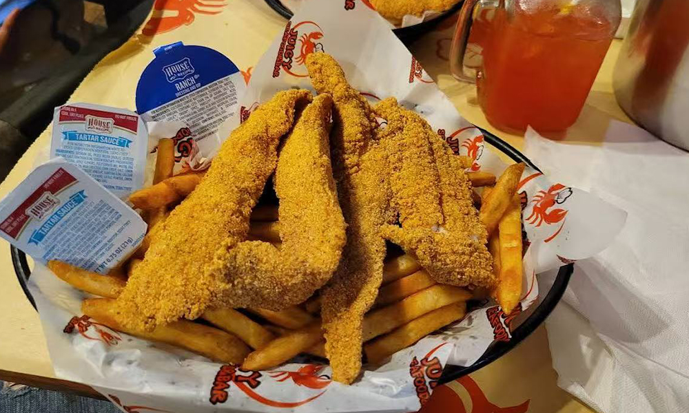 Crispy fried catfish served with golden French fries at Cajun Bros, a Seafood Restaurant in Waxahachie